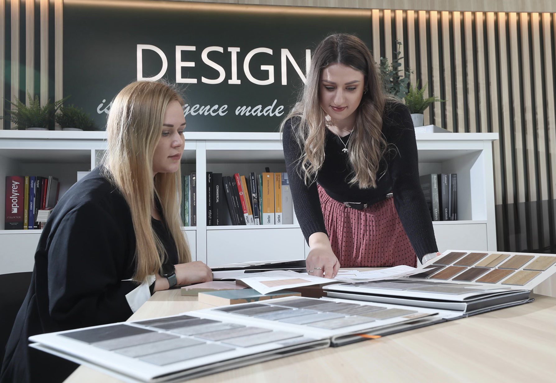 Two colleagues reviewing colour and material samples at a table in the ONOVO design studio