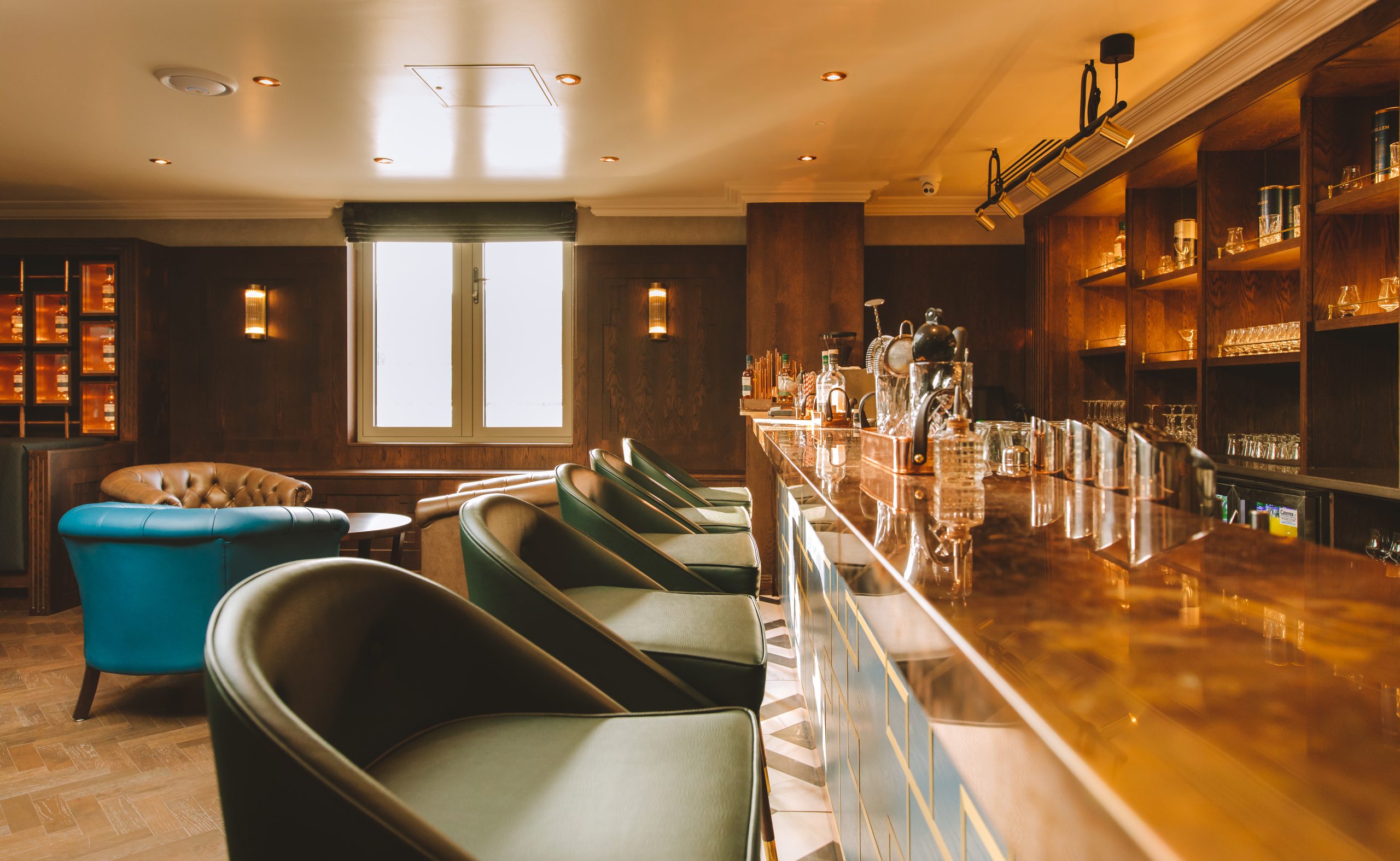 Elegant Whiskey Bar, Green Leather Chairs Ambient Lighting. Oak Wood Bar