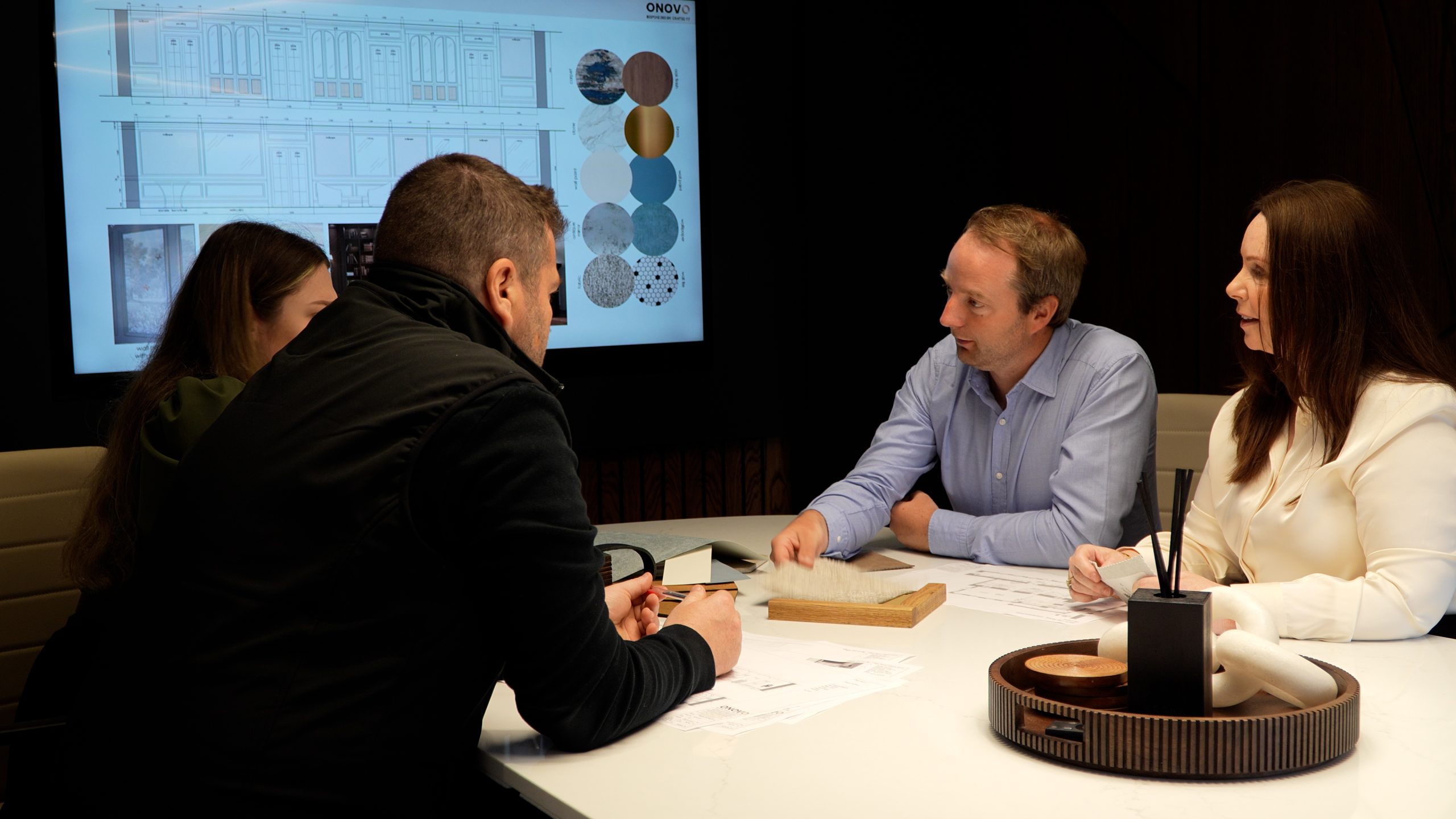 ONOVO colleagues reviewing architectural plans together in a conference room during fit-out planning
